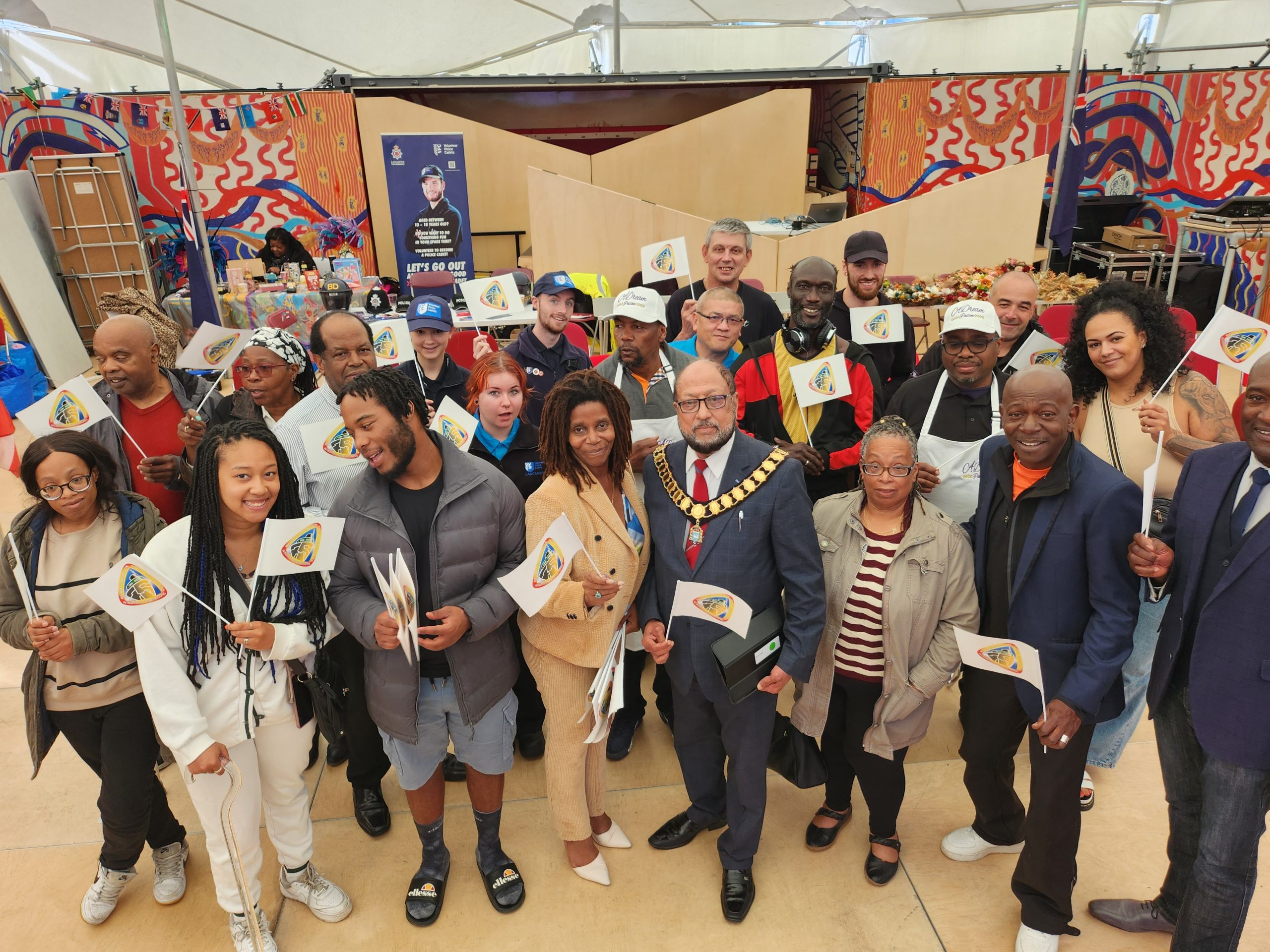 A group photograph of attendees at a Windrush celebration event at the MET.