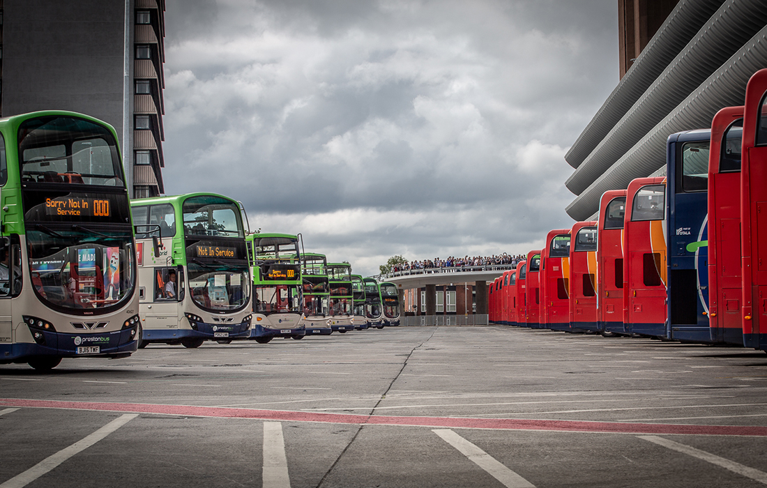 The buses carry out the choreographed movements as a crowd watches on from the bus station access ramp.