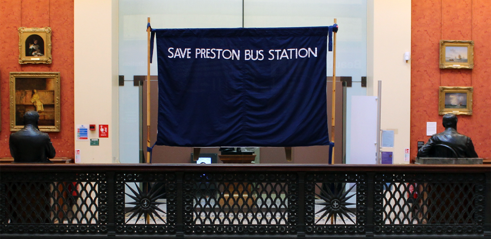 The exhibition in the Harris Museum. The rear of a handstitched 'Save Preston Bus Station' banner displayed on the 2nd floor landing.