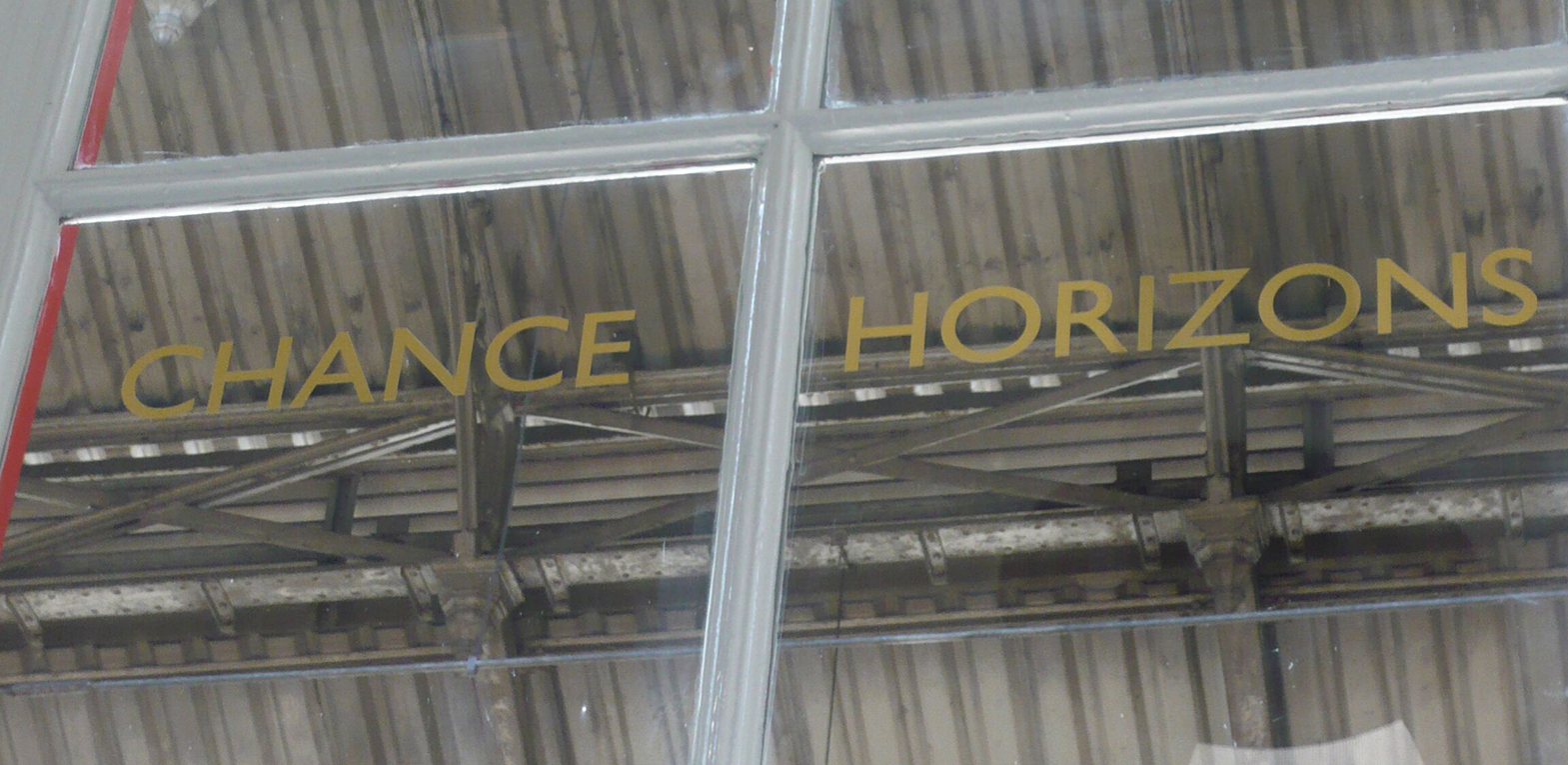 Letters on the windows of the waiting rooms of Preston train station as part of an artwork by Lisa Wigham. The words say 'chance horizons'